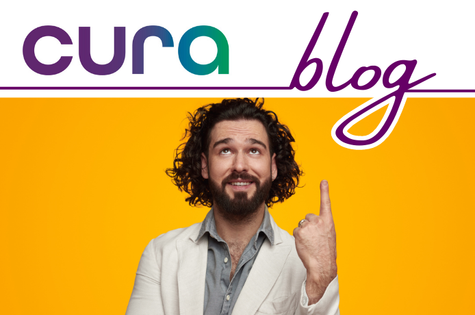 A man smiling pointing to the top of the image that says Cura blog